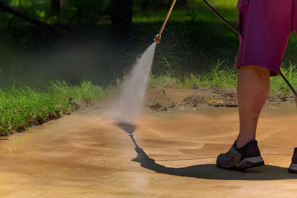 Professional pressure washing service cleaning concrete driveway surface